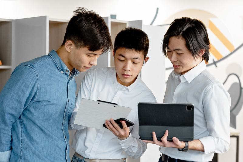 Colleagues reviewing documents together on tablets