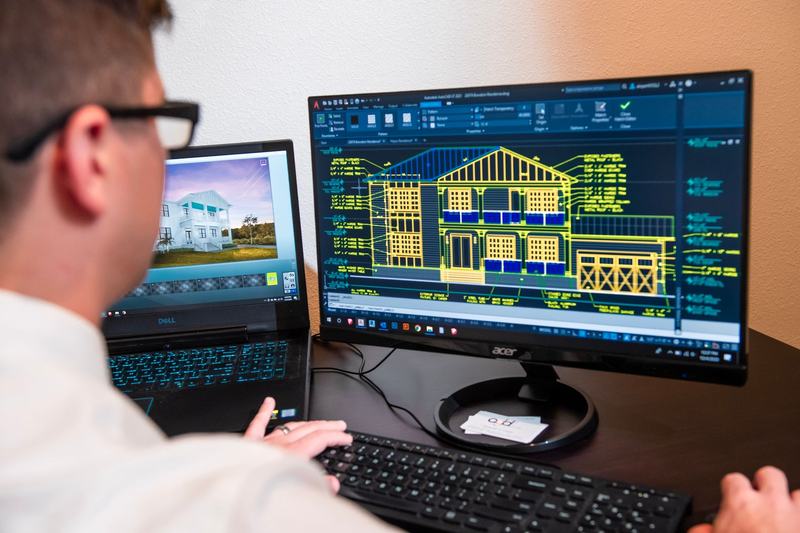Designer working with CAD software on a monitor