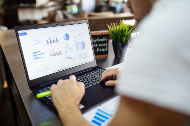 Charts and tables on a laptop screen
