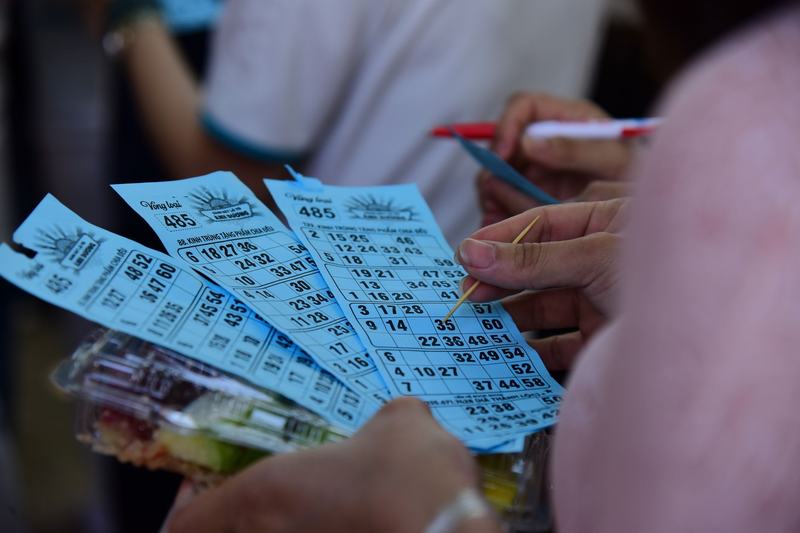 Hands holding paper tickets
