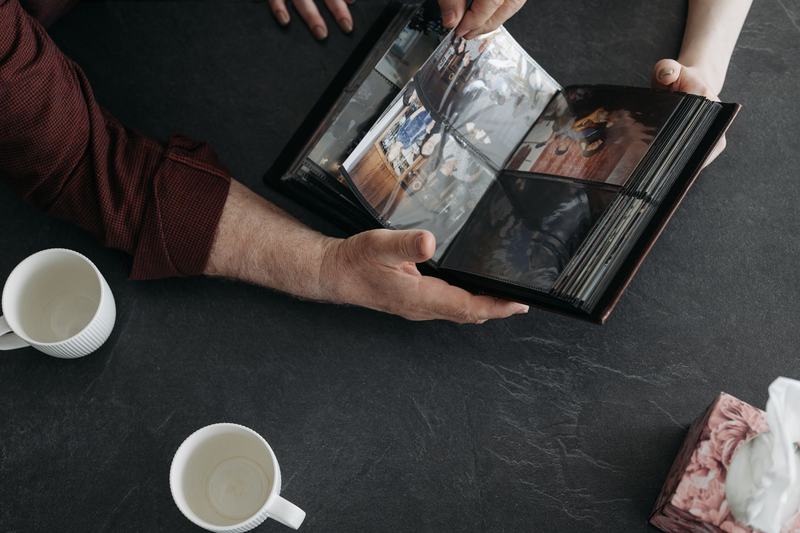 Hands paging through a printed photo album