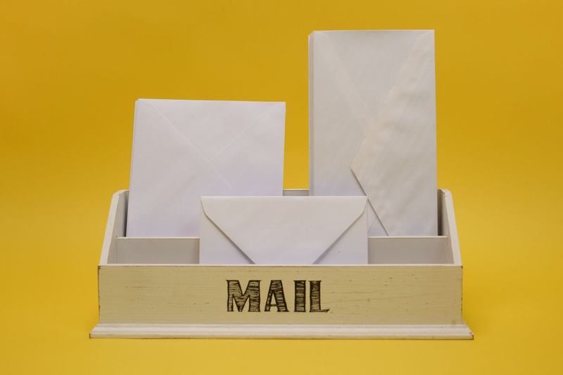 White envelopes in a small mail holder