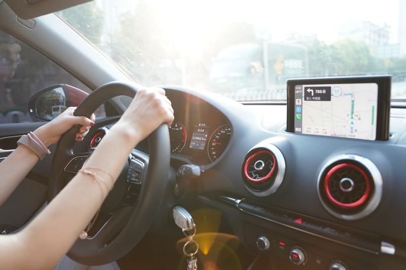 Driver using a navigation display on a car dashboard