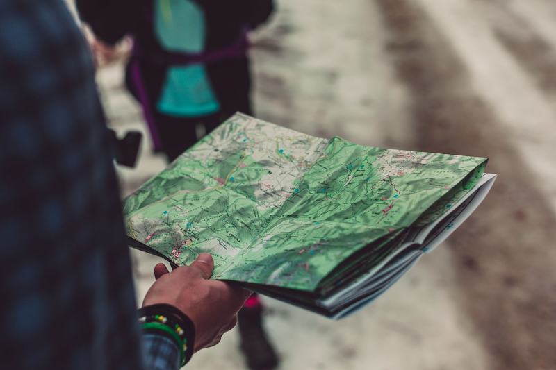 Traveler holding a folded paper road map
