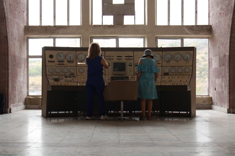 Operators standing at large switching panels in a hall