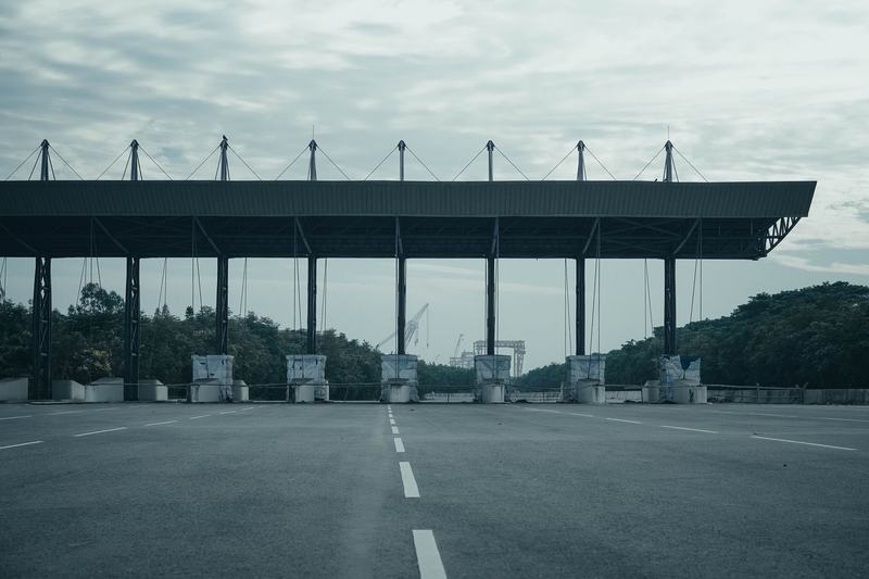 Overhead toll structure spanning an empty highway