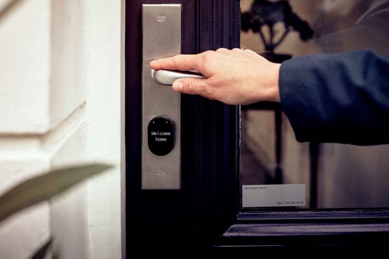 Hand touching an electronic door lock