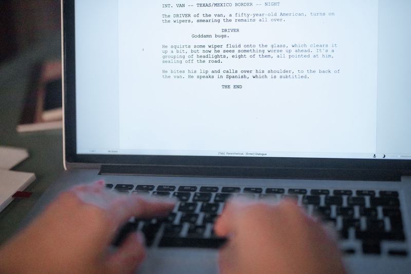 Hands typing a document on a laptop
