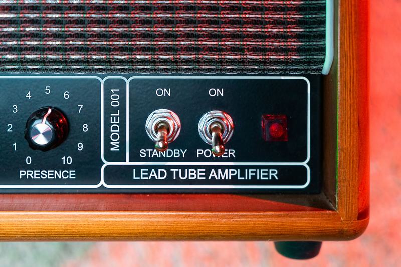 Vintage tube amplifier panel with switches and a control knob